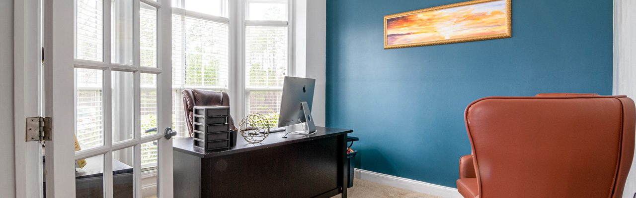 Office with Dark Blue Accent Wall used for About Us Header