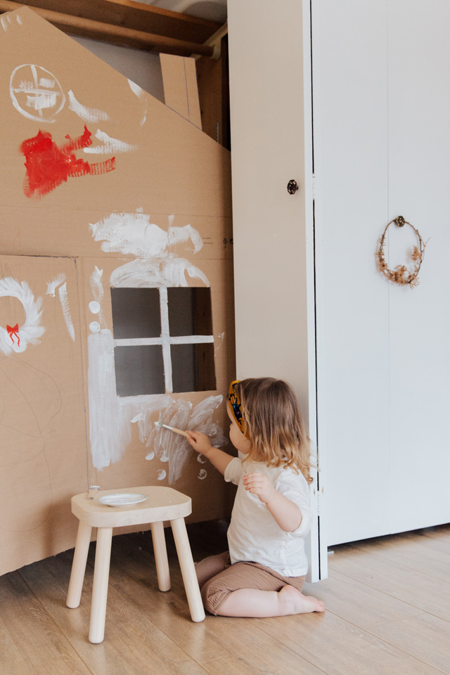 Toddler Girl Painting Cardboard Playhouse